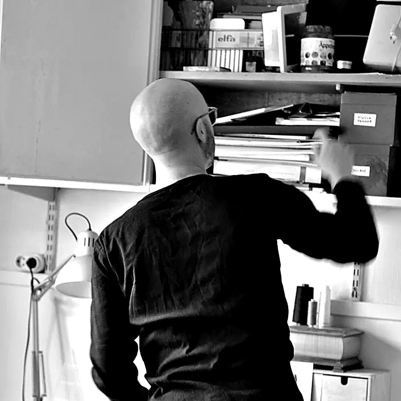 Black-and-white portrait of illustrator Alexander Adiels in his Stockholm studio