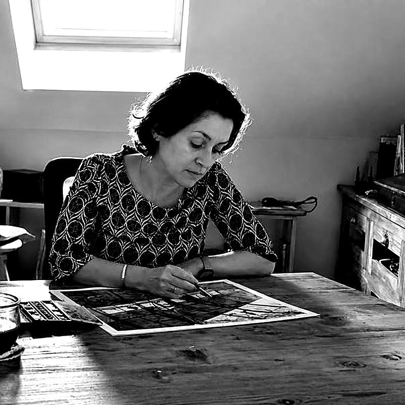 Portrait of watercolor and cyanotype artist Aline Demarais at work in her studio