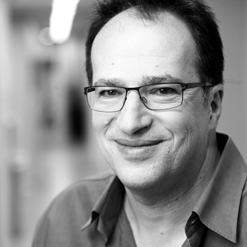 Black-and-white portrait of photographer Amnon Eichelberg